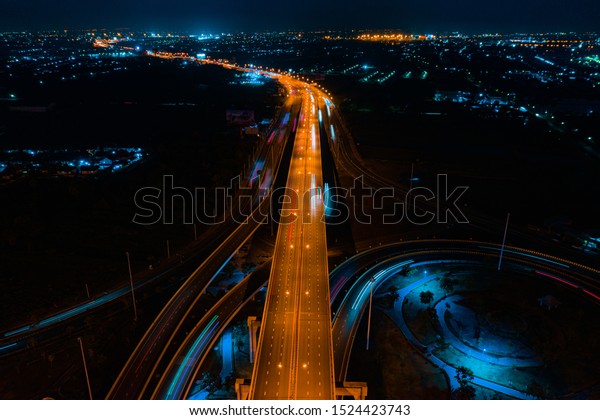Rail\
track and conductor rail transportation, Aerial top view, Road\
Expressway traffic highway roundabout transportation with moving\
cars and railway tracks on which the train\
rides