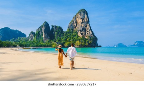 Railay Beach Krabi Thailand, the tropical beach of Railay Krabi, a couple of men and women walking on the beach, idyllic Railay Beach in Thailand. Couple on vacation holiday in Thailand