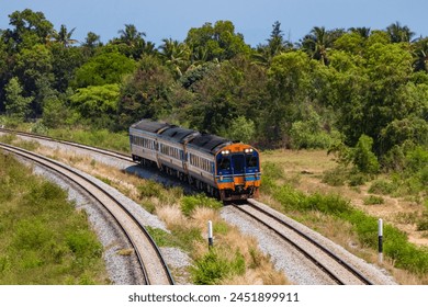 Railcar in curve near Prachuap Khiri Khan at noon.
