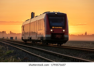 Railcar driving through the countryside in a beautiful misty sunrise - Powered by Shutterstock