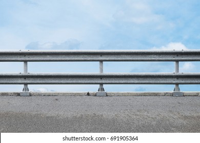 railing at road side on blue sky background