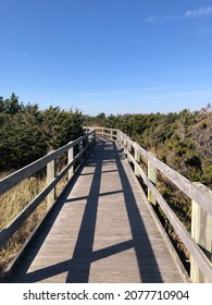Railing shadows on the boardwalk. Boardwalk trail to the Fire Island Light Station.