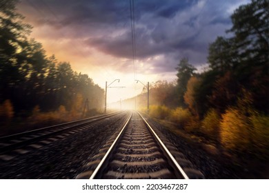 Railroad in the autumn forest. Railway tracks through the forest. Motion blur effect. - Powered by Shutterstock