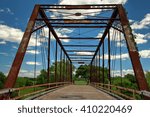 Railroad bridge over a gravel road in rural Texas