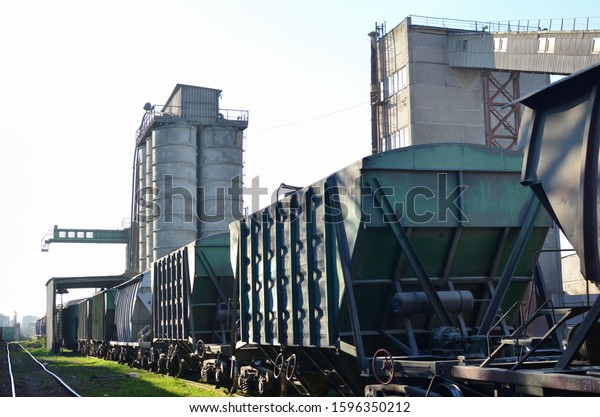 Railroad cars at cement manufacturing plant.\
Ready-mix and building materials. End products being shipped by\
rail from the concrete factory. Freight cars, hopper car for sand\
or mineral products