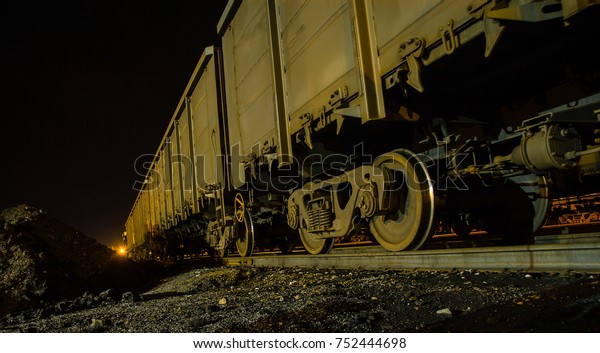 railroad cars loaded with\
coal, the train transports coal.\
loading of wagons with coal.\
night views.