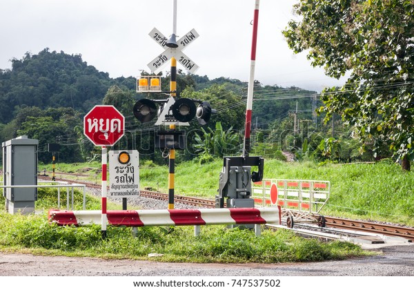 Railroad\
crossing warning sign, Thai langue in road sign mean \