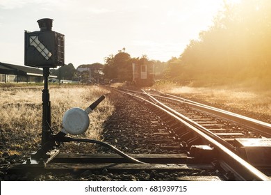 Railroad switch with train in the morning sun.