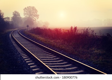 Railroad track during autumn foggy morning in countryside