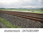 the railroad track and also the scattered gravel part of the railroad track