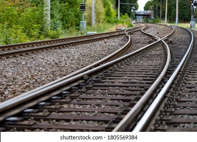 Railroad Tracks In A Countryside Surroundes By Trees, Electrical Overhead Line, Outdoors, With A Switch