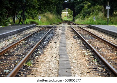 Railroad Tracks Image Of Railway Road Closeup. On The Train Track. Train Tracks Going Through The Isle Of Man Tunnel Arch.Rail Railroad Tracks Background. Railroad Track Sunny Day