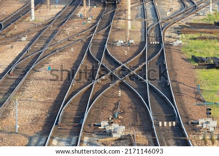 Railroad tracks on station. Crossover point in railway sidings. Railroad tracks crossing over each other. Concept of choosing the path and the consequences of making a decision.