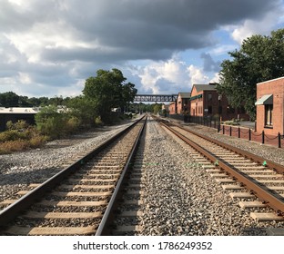 Railroad Tracks Passing By A Row Of Brick Warehouses In Marietta, Georgia