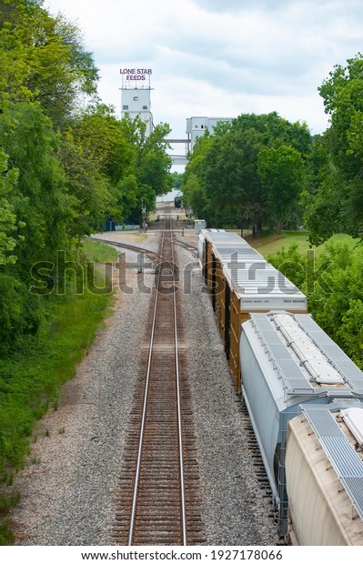 Railroad\
tracks and rail cars in line outside a\
business