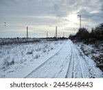Railroad tracks and road in winterly Germany.