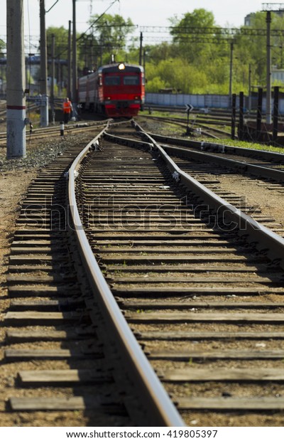 Railroad tracks and\
wagons bright sunny\
day