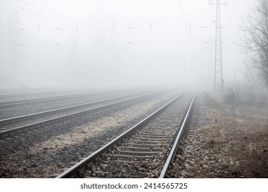 Railroad tracks without a train in daytime winter fog. - Powered by Shutterstock