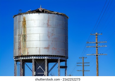 Railroad Water Tank With Clue Sky And Power Lines