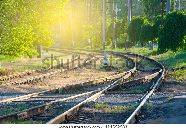 The rails and the arrow for the railway, the fork\
of the road. Tinted image