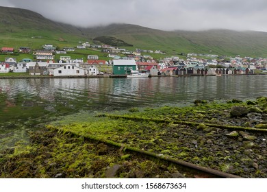 Rails On A Boat Ramp, Covered In Algae, Boathouses At The Back, Vágar, Faroe Islands, Denmark