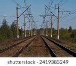 The rails of the railway run away over the horizon.