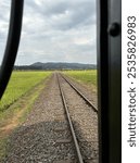 Railtracks with the mountain and rice fields on the background