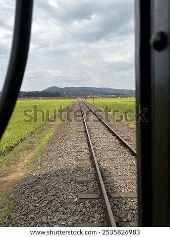 Railtracks with the mountain and rice fields on the background