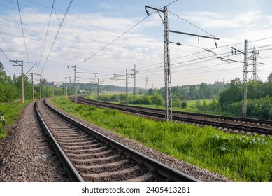 Railway against a beautiful colorful sky at sunset. Industrial landscape with railroad, blue sky with clouds in summer. Railway junction in the evening. - Powered by Shutterstock