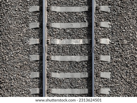 Railway background texture. Steel rails mounted on gray concrete sleepers. Industrial transportation photo pattern