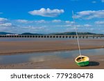 Railway Bridge at Arnside Bay. A small fishing boat on the shore at Arnside in the English Lake District, Great Britain