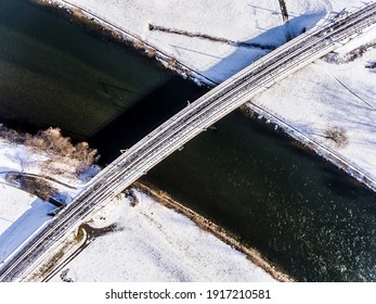 A Railway Bridge Over A River During Winter Season With Snow