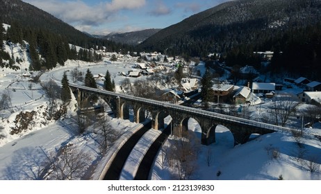 Railway Bridge Viaduct Over A Highway In The Mountains With Snow And Frost