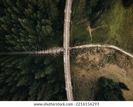 Railway bridge - Viaduct of Telgart in Europe Slovakia from above (top view) with beautiful pine forest and path under the viaduct. Aerial photo of crossroad by drone - wide angle view.