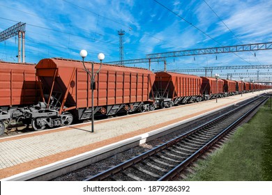railway carriage grain carrier for transporting agricultural crops at the station on a sunny day, freight cars with bulk cargo, nobody.