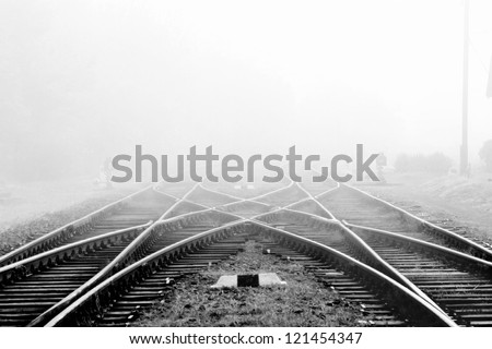 Railway in fog on station, outdoor landscape