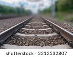 Railway lines closeup. Train tracks with track ballast stones, metal rails, railway track