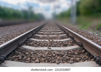 Railway lines closeup. Train tracks with track ballast stones, metal rails, railway track
