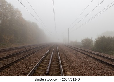 Railway Lines Converge In The Distance In A Light Bank Of Fog One Winter Morning In Offord Cluny, Cambridgeshire, United Kingdom