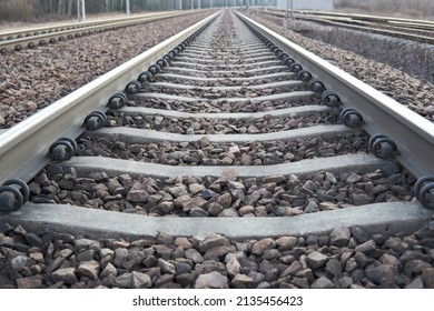 Railway lines with track ballast. Train tracks underlay, rails and crushed stones. Industrial landscape. Railway junction. Heavy industry. Railway track.                       - Shutterstock ID 2135456423
