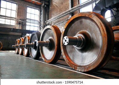 Railway / Metal train wheels with rust in Carriage-building Factory, Repair shop, wide angle image. Locomotives and rolling-stock repair, Industrial background, metalworking factory storage