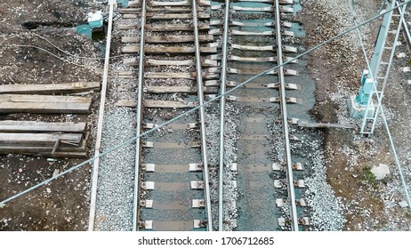 Railway. An Old, Abandoned Railway With Rusty, Steel Rails, Wooden Sleepers, Puddles Of Water After Rain And Gray Stones (rubble). Transport Industry Background. Business Logistics,import. Template. 