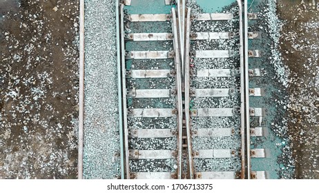 Railway. An Old, Abandoned Railway With Rusty, Steel Rails, Puddles Of Water After Rain And Gray Stones (rubble). Transport Industry Background.Business Logistics,import.Template.