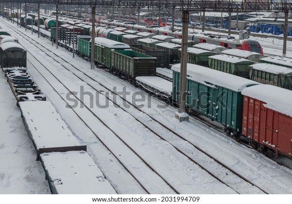 The railway station is covered with\
snow along with the cars. View from above. The concept of railroad\
transportation. Krasnodar, Russia, February 18,\
2021