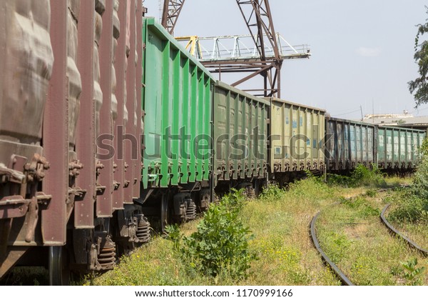 Railway station with freight cars in industrial\
depot of the power plant. Colorful industrial landscape. Railway in\
depot. The railway platform. Heavy industry. Cargo transportation\
by railroad cars