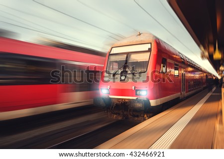 Railway station with modern high-speed  passenger train in motion blur effect Nuremberg, Germany. Railroad