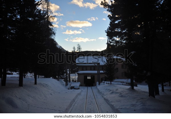 Railway and\
station in the snow, Muottas\
Muragl