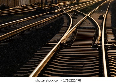 Railway switch and parallel tracks glowin in the warm light of sunset in Hagen-Hohenlimburg Germany. Tresholds, screws and interchange as symbol für transportation. Main line from Hagen to Siegen. - Powered by Shutterstock