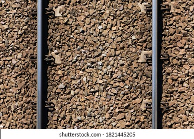 Railway Top View Background. Train Transport Industry. Rail Track Texture. Good And Cheap Way Of Transportation For Cargo. Old Railroad Wooden Tie. Track Ballast Gravel Made Of Crushed Stone.