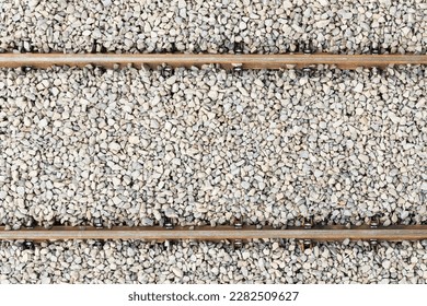 Railway top view background. Train transport industry. Rail track texture. Good and cheap way of transportation for cargo. Old railroad wooden tie. Track ballast gravel made of crushed stone.	